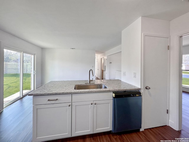 kitchen featuring dishwasher, sink, dark wood-type flooring, white cabinets, and light stone counters