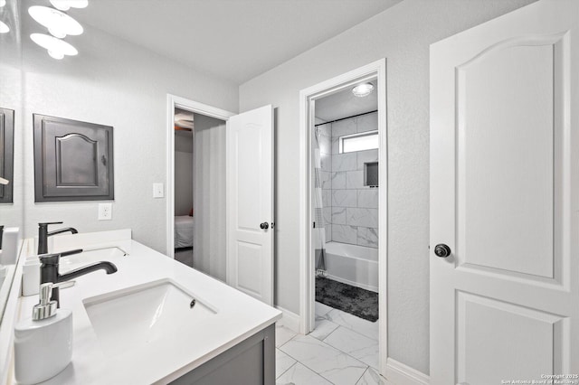 bathroom featuring tiled shower / bath combo and vanity