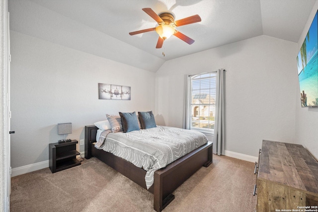 bedroom with ceiling fan, light colored carpet, and lofted ceiling