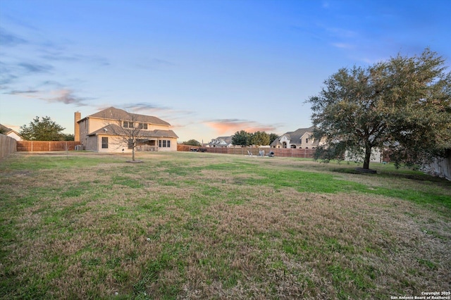 view of yard at dusk