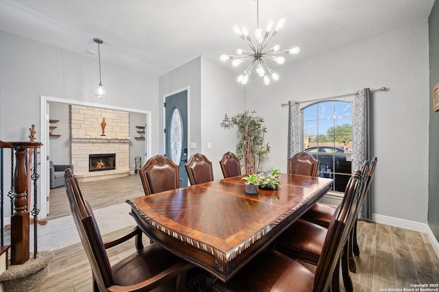 dining area with a fireplace and a notable chandelier