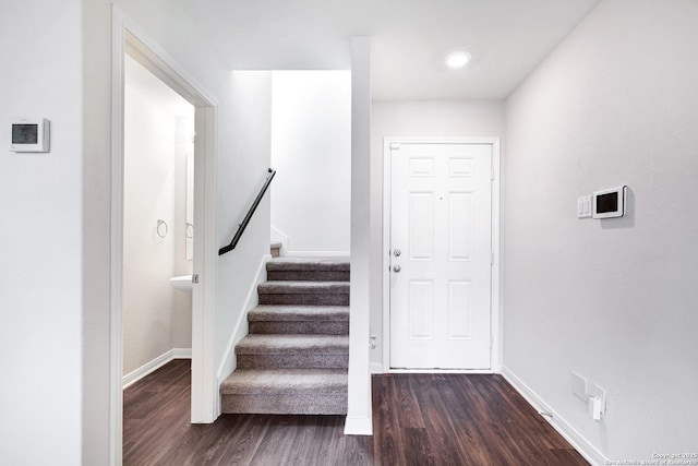 stairway with hardwood / wood-style floors