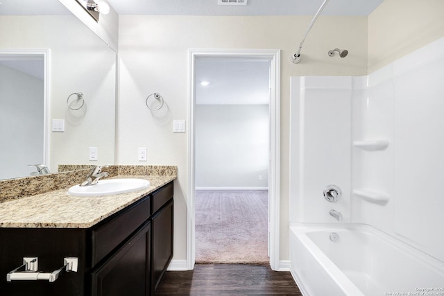 bathroom with wood-type flooring, bathtub / shower combination, and vanity