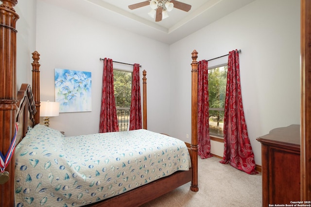 bedroom with light carpet, ceiling fan, and multiple windows