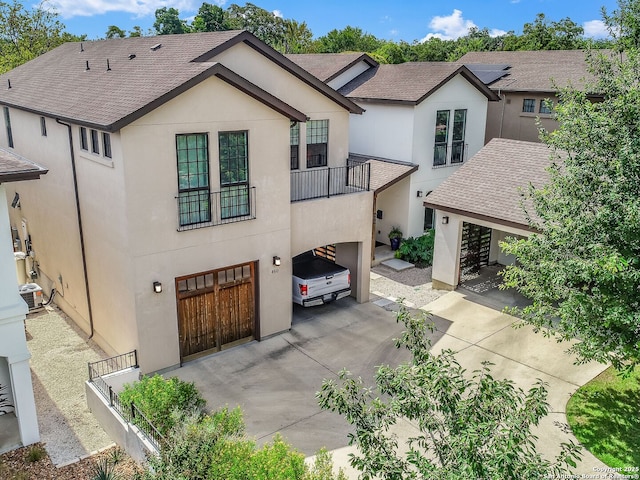 view of front of home with a balcony and a garage