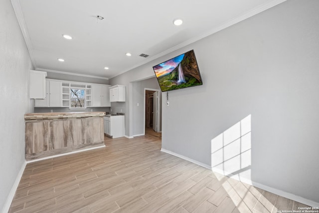 kitchen with white cabinetry and crown molding