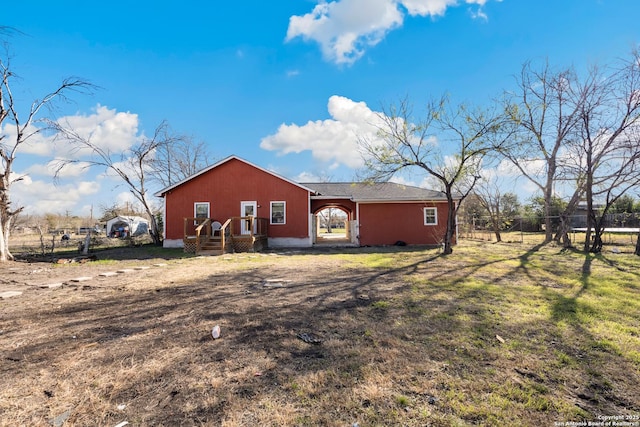 rear view of house with a yard