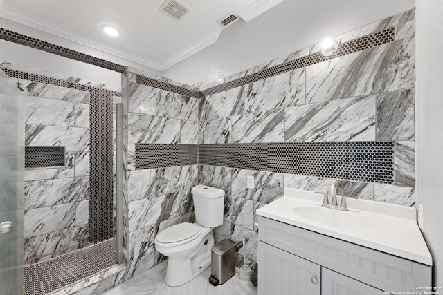 bathroom with toilet, a tile shower, tile walls, ornamental molding, and vanity