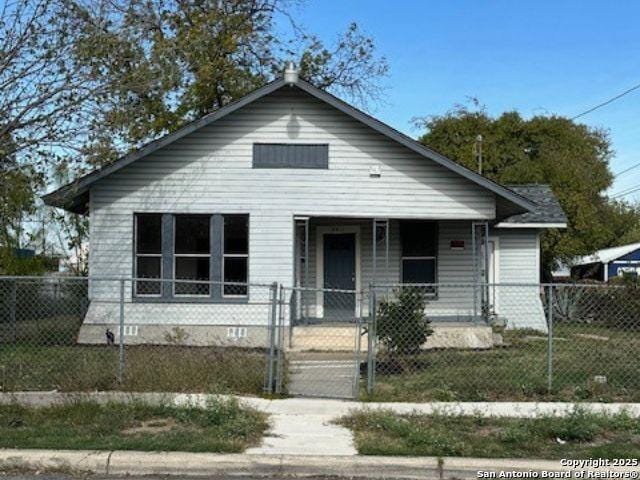 bungalow-style home with covered porch and a front yard