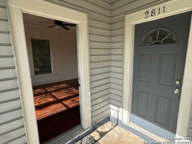 view of exterior entry with ceiling fan