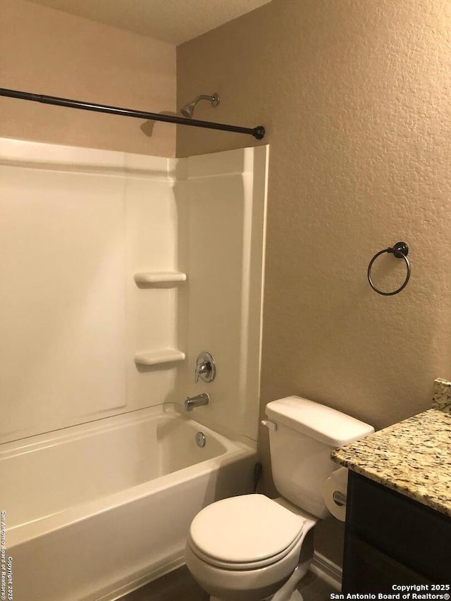 full bathroom with toilet, vanity, and  shower combination