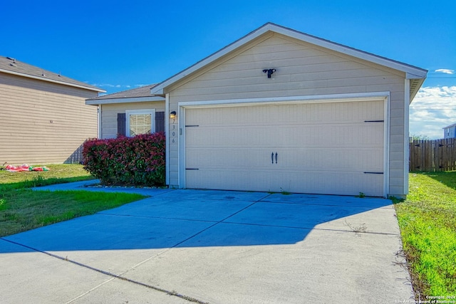 ranch-style house featuring a front lawn and a garage