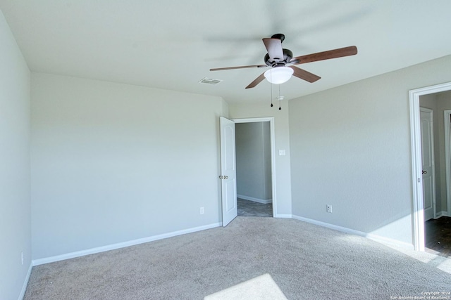 carpeted spare room with ceiling fan