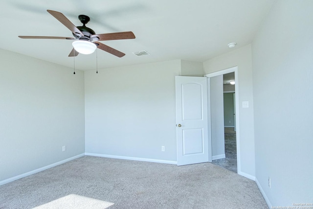 carpeted spare room featuring ceiling fan