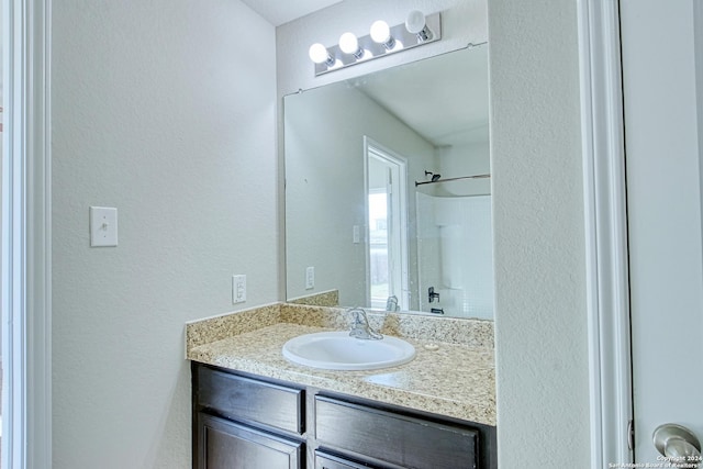 bathroom with vanity and walk in shower