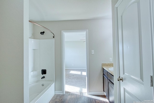 bathroom with  shower combination, hardwood / wood-style flooring, and vanity