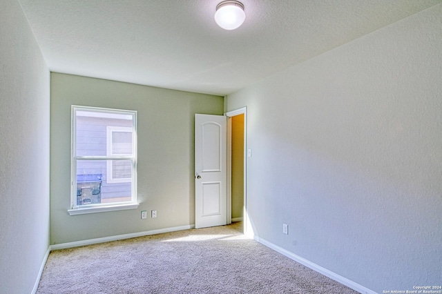 empty room featuring light carpet