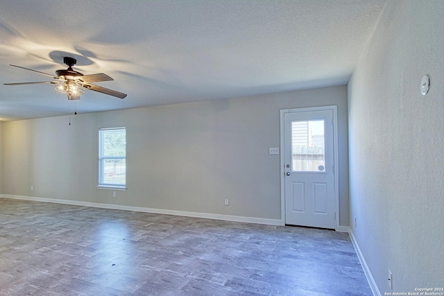 spare room with ceiling fan and a textured ceiling