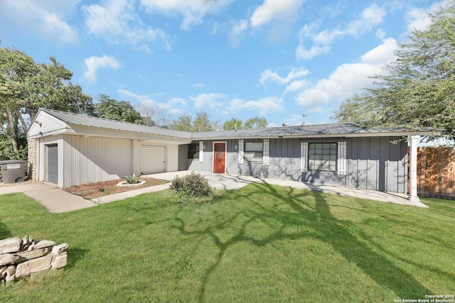 ranch-style home with a garage and a front yard