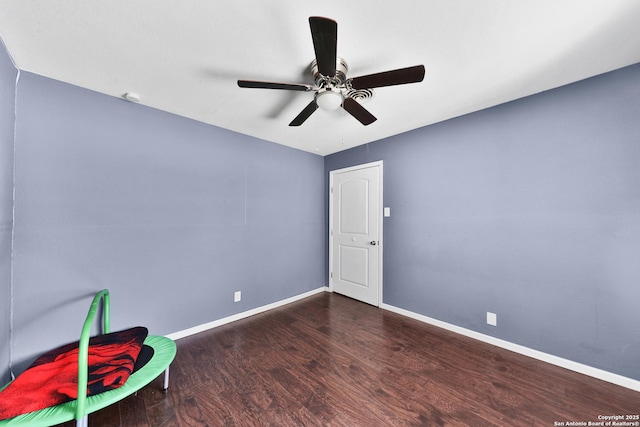 unfurnished room featuring ceiling fan and dark hardwood / wood-style floors