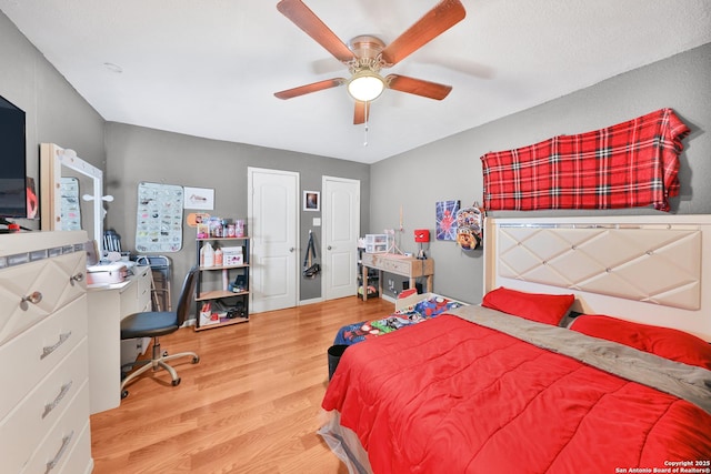 bedroom with ceiling fan and light hardwood / wood-style flooring