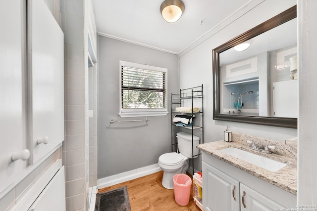 bathroom with hardwood / wood-style floors, toilet, vanity, and crown molding