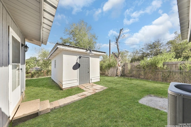 view of yard featuring a shed and central air condition unit