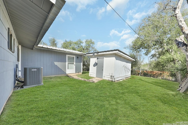 view of yard with cooling unit and a storage unit