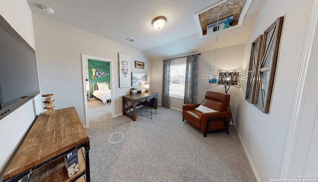 sitting room with lofted ceiling, a textured ceiling, and carpet flooring