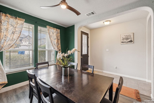 dining room featuring ceiling fan, a textured ceiling, and hardwood / wood-style floors