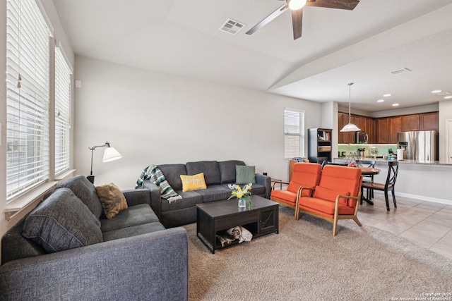 tiled living room with ceiling fan and lofted ceiling