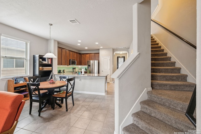 dining area with light tile patterned floors