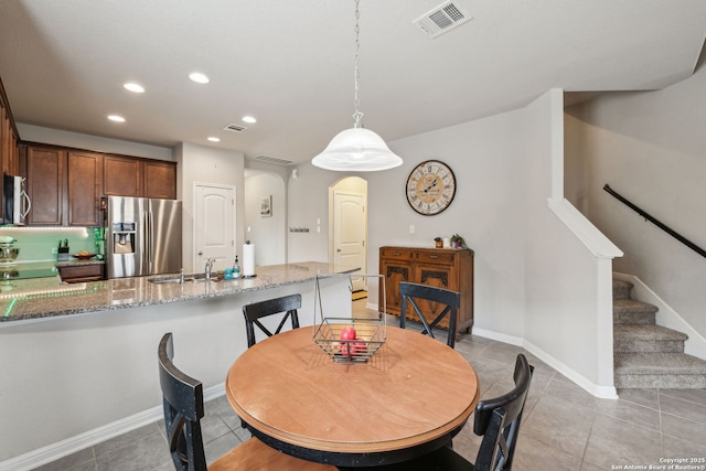 tiled dining space featuring sink