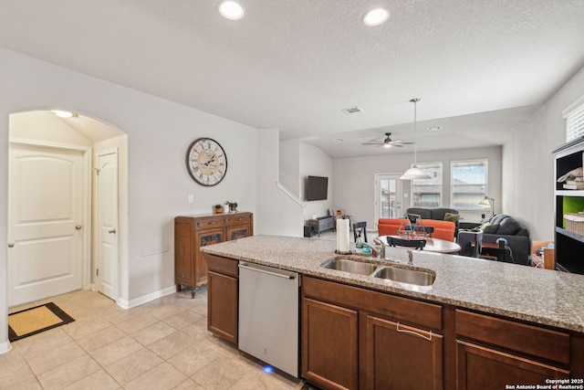 kitchen with light stone countertops, dishwasher, sink, ceiling fan, and light tile patterned floors