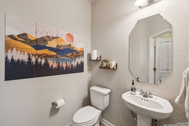 bathroom featuring sink and toilet