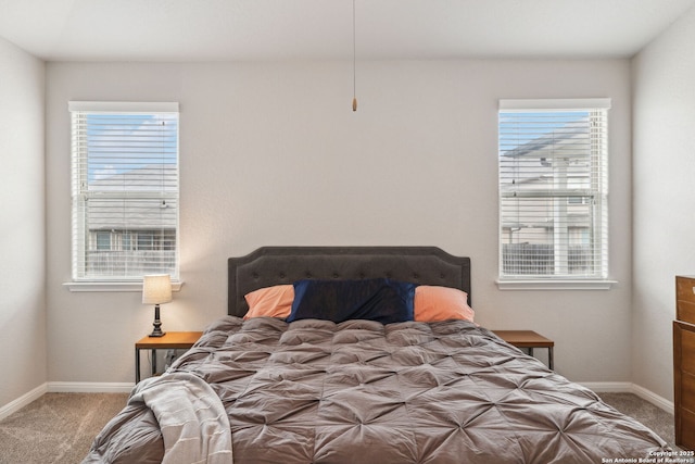 carpeted bedroom featuring multiple windows