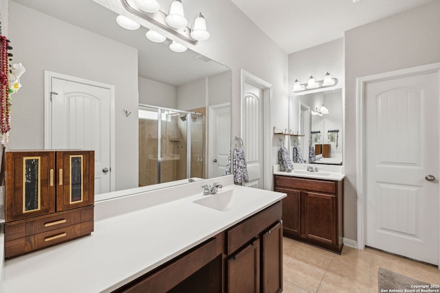 bathroom with tile patterned floors, vanity, and a shower with shower door