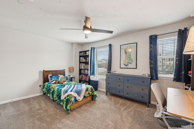 bedroom featuring ceiling fan, multiple windows, and carpet