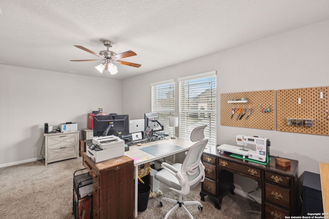 carpeted home office featuring ceiling fan and a textured ceiling