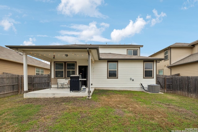 back of house with a lawn, central AC, and a patio area