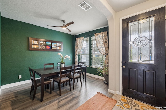 dining area featuring a textured ceiling, ceiling fan, and hardwood / wood-style flooring