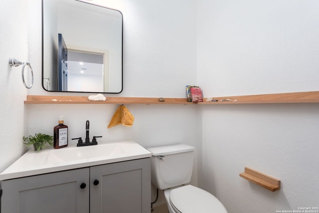 bathroom with toilet and vanity