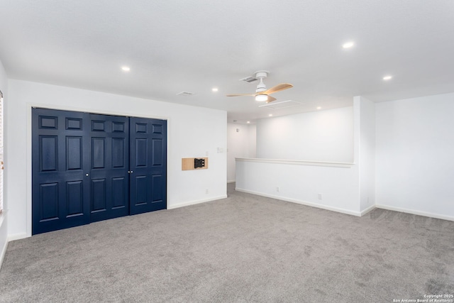 interior space with ceiling fan and carpet