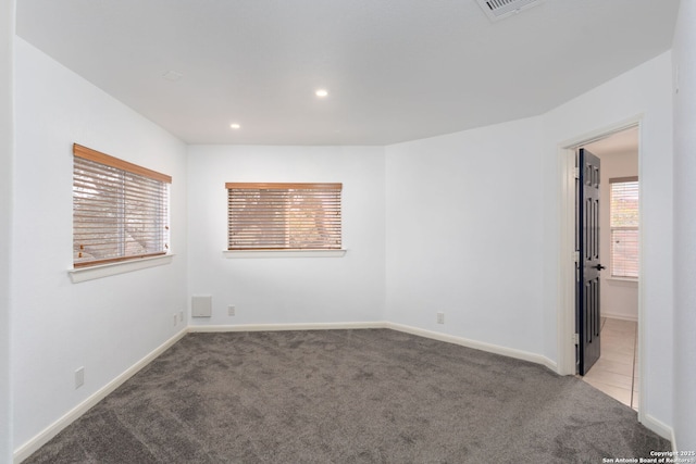 spare room with light carpet