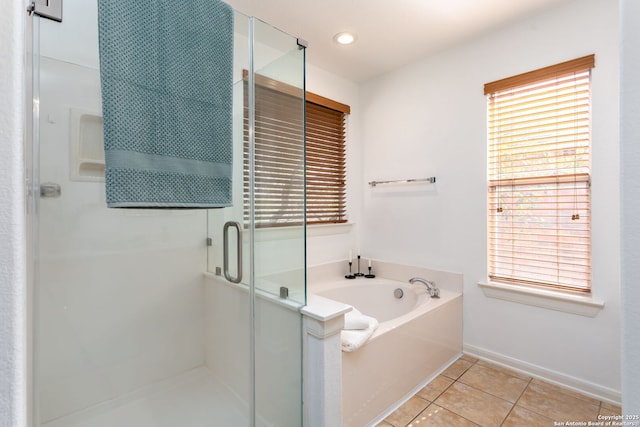 bathroom featuring plus walk in shower, tile patterned floors, and plenty of natural light