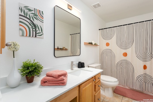 bathroom featuring tile patterned floors, vanity, and toilet