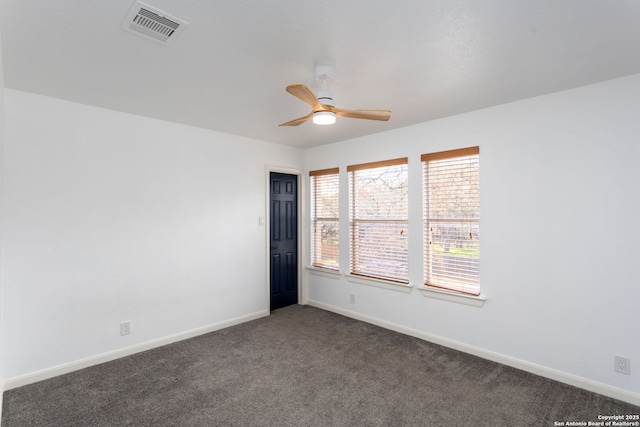 carpeted spare room featuring ceiling fan