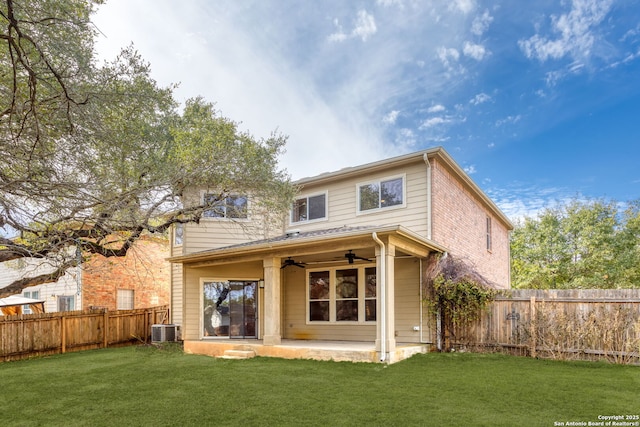 rear view of house featuring ceiling fan, cooling unit, a yard, and a patio