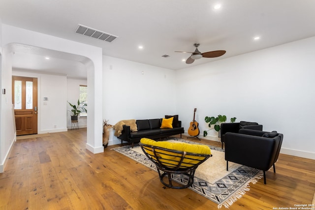 living room with light hardwood / wood-style floors and ceiling fan