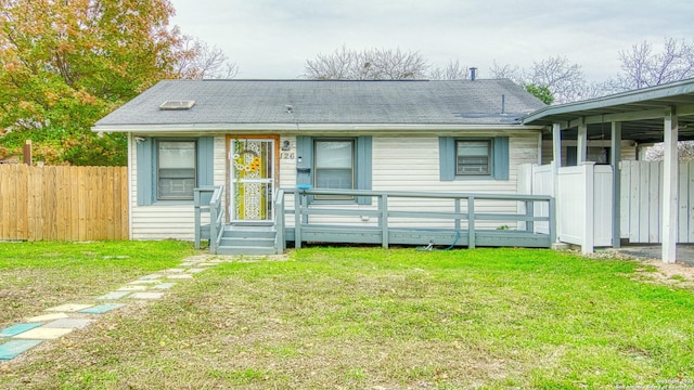 rear view of house featuring a lawn